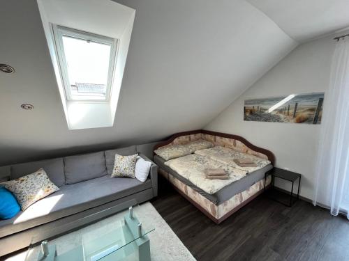 a living room with a bed and a couch at Holiday Apartment Žabovřesky in Hluboká nad Vltavou