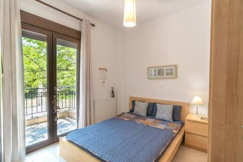 a bedroom with a bed and a balcony at Serenity Cove, The Fox s Lair Hospitality in Agia Paraskevi