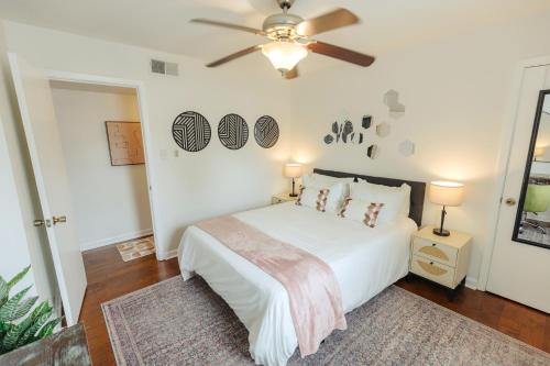 a bedroom with a white bed and a ceiling fan at Centrally Located 2BR Overton Square Unit 1 Fast WiFi Free Parking Yes Pets in Memphis