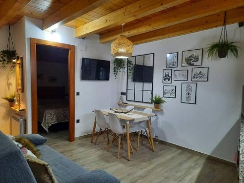 a dining room with a table and chairs in a room at mcastet, casita aranesa en el valle de aran in Bossost