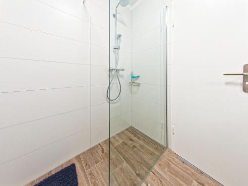 a shower with a glass door in a bathroom at Mein Strand Apartment in Scharbeutz