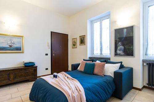 a bedroom with a blue bed and a couch at [Sweet Arona] Beautiful Apartment, Netflix - Wi-Fi in Arona