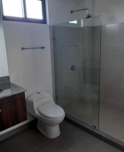 a bathroom with a toilet and a glass shower at Zona Comercial Nuevo Vallarta in Nuevo Vallarta 