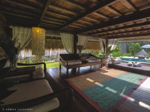 a living room with a couch and a table at Sandat Glamping Tents in Ubud