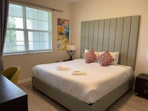a bedroom with a large bed with two towels on it at Modern 3B2b APT near Convention Center Universal and all Theme Park 7 in Orlando