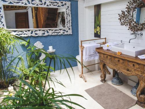 a bathroom with a sink and a mirror at Sandat Glamping Tents in Ubud