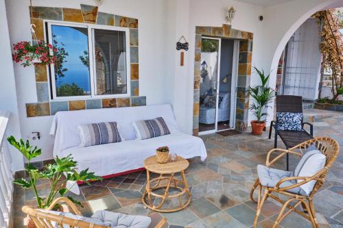 a living room with a couch and chairs on a patio at Tizziri rural in Santa Cruz de Tenerife