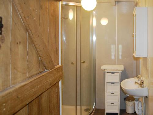 a bathroom with a shower and a sink at Shire Cottage in Highpeak Junction