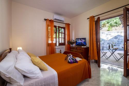 ein Schlafzimmer mit einem Bett mit einer orangefarbenen Decke in der Unterkunft Villa La Natura x9 Whole villa with private parking in Sorrent