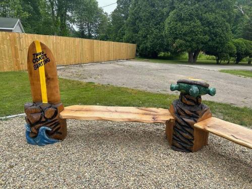 a wooden bench sitting on top of a gravel field at Pickleball Paradise in South Haven