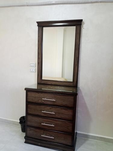 a dresser with a mirror on top of it at Jerash air apartment in Jerash
