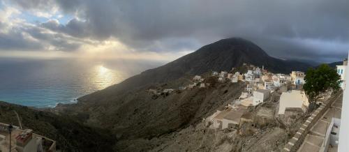 a mountain with a town on top of it at Oxo Kamara Apartment in Karpathos Town