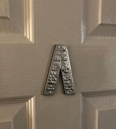 a letter a is hanging on a door at AC Lounge 125 in Rochford