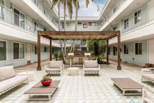 an outdoor patio with couches and tables in a building at East Village Arts District, King Suite with Sofa Bed NRP26-02357 in Long Beach