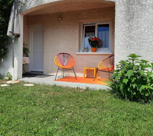 two chairs sitting on the porch of a house at Le Lac in Tresserves