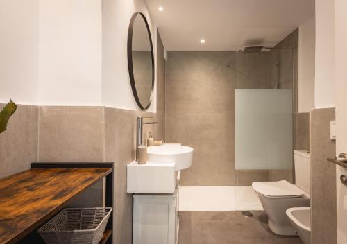 a bathroom with a sink and a toilet and a mirror at Apartment Puerto Banus Marbella in Marbella