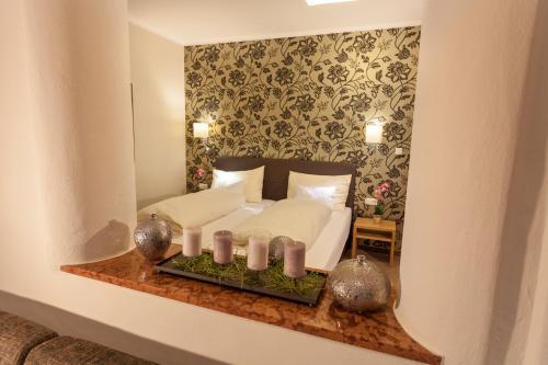 a bedroom with a bed in a mirror at Hotel Pass Lueg in Golling an der Salzach