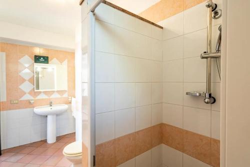 a bathroom with a shower with a toilet and a sink at Dimora Calliope in Naso