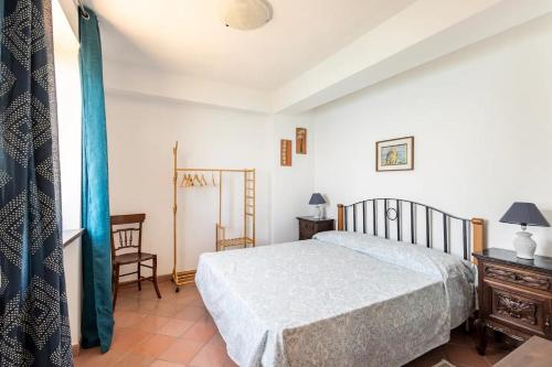 a bedroom with a bed and a table and a chair at Dimora Calliope in Naso