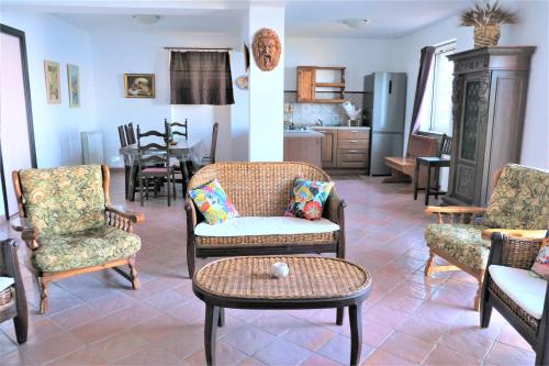 a living room with chairs and a table at Dimora Calliope in Naso