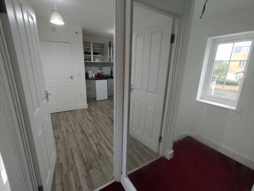 a hallway with a door and a window in a room at Charming Studio Flat with Parking in Enfield
