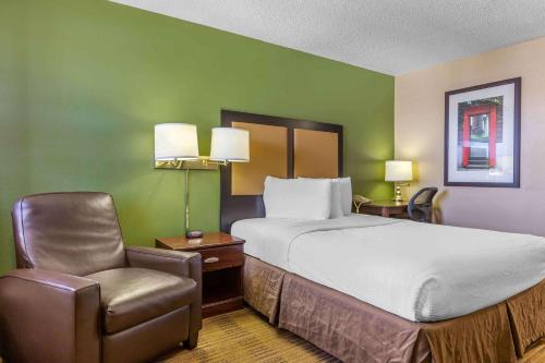 a hotel room with a bed and a chair at Extended Stay America Suites - El Paso - Airport in El Paso