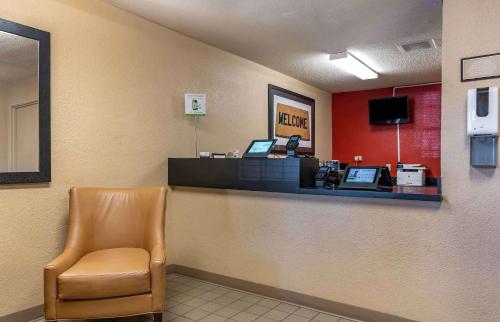 a waiting room with a cash register and a chair at Extended Stay America Suites - Lexington - Nicholasville Road in Lexington