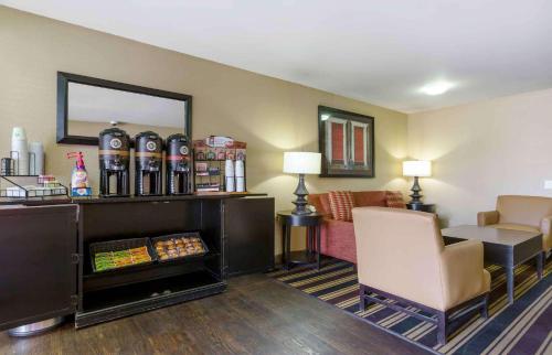 a hotel room with a waiting area with a table and a chair at Extended Stay America Suites - El Paso - West in El Paso