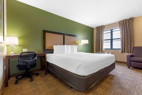 a hotel room with a bed and a desk and a chair at Extended Stay America Suites - Waco - Woodway in Waco