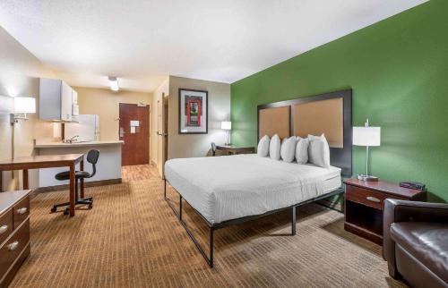 a hotel room with a bed and a kitchen at Extended Stay America Suites - Indianapolis - Airport in Indianapolis