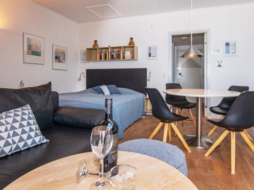a living room with a couch and a table with a wine glass at Apartment Hejls VI in Hejls