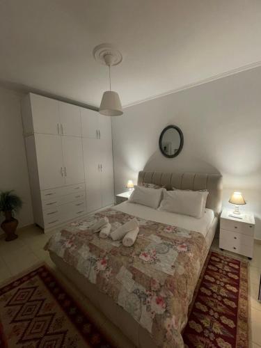a bedroom with a bed with two stuffed animals on it at Meg’s Apartment in Gjirokastër