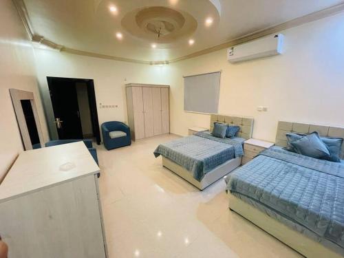 a large room with two beds and a counter at شقة واسعة بفناء خاص و دخول ذاتي in Al Madinah