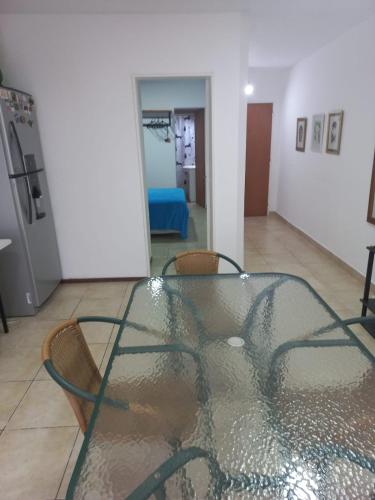 a glass table and chairs in a room at Depto Luminoso 1 Dormitorio para 2 con Patio in Rosario
