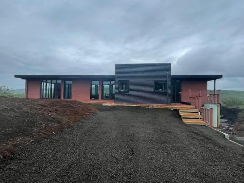 a house on top of a hill with a driveway at Modern villa - in Golden Circle - Gullfoss Geysir Þingvöllur - Freyjustíg 13, 805 Selfoss in Búrfell