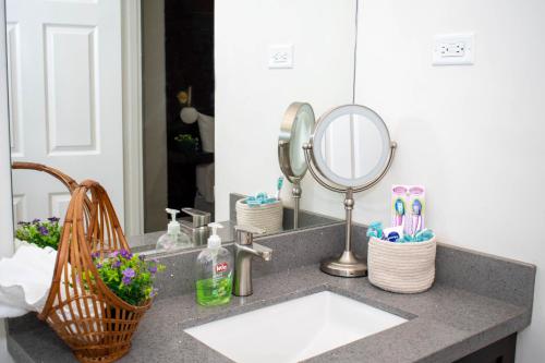 a bathroom counter with a sink and a mirror at King Bed Studio/Gated/Fast Wi-Fi/Near Ocho Rios in Boscobel