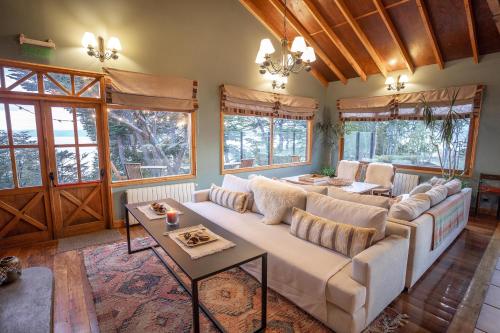 a living room with a couch and a table at Los Ñires Ushuaia in Ushuaia