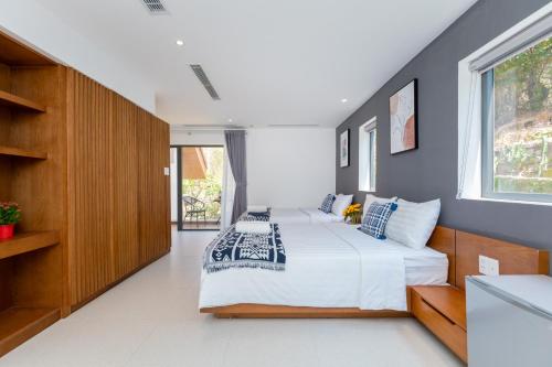 a bedroom with two beds and a window at Cosa villages in Vung Tau
