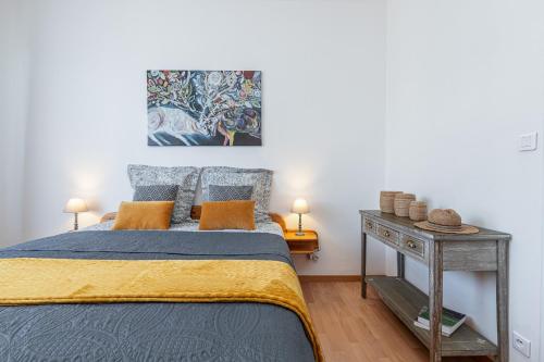 a bedroom with a bed and a painting on the wall at The place to be in Nice in Nice
