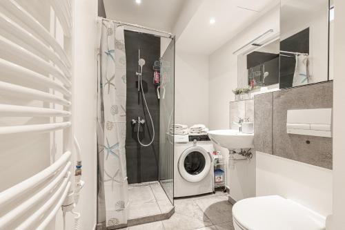 a bathroom with a shower and a washing machine at The place to be in Nice in Nice