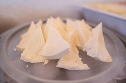 a pile of cheese on top of a plate at Pousada Rotunda in São João del Rei