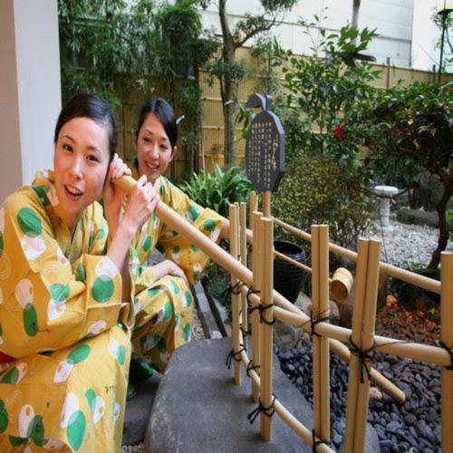 two women in kimonos sitting next to a fence at Yuyado Mikannoki in Atami