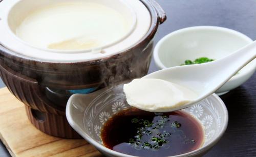 a bowl of soup with two spoons on a table at Yuyado Mikannoki in Atami