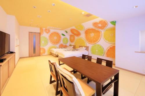 a dining room with a table and a bedroom at Yuyado Mikannoki in Atami