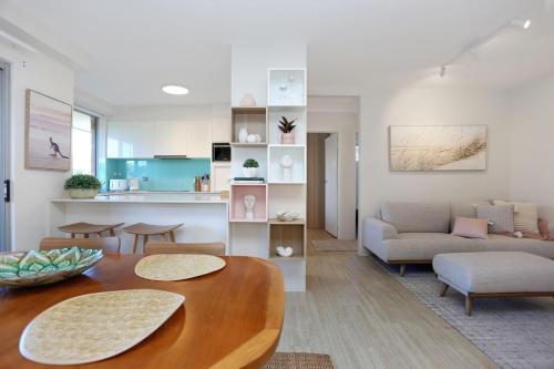 a living room with a table and a couch at Seacrest 7 in Hawks Nest