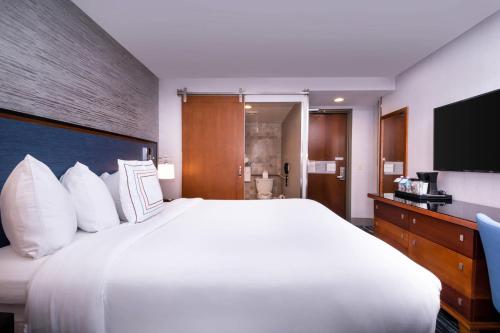 a large white bed in a hotel room at Fairfield Inn & Suites By Marriott New York Manhattan/Times Square in New York