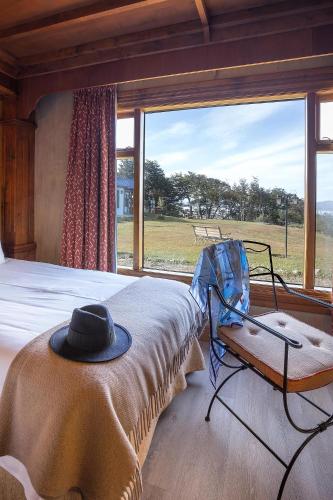 a bedroom with a bed with a hat on it at Los Ñires Ushuaia in Ushuaia