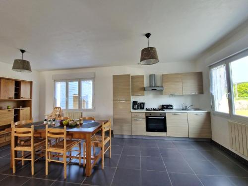 une cuisine avec une table et des chaises dans une pièce dans l'établissement Holiday Home near Cap Frehel Emerald Coast, à Plévenon