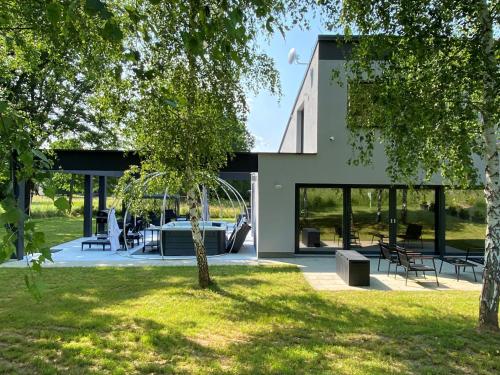 a house with a pool in the middle of a yard at Country house Greenfields in Gospić