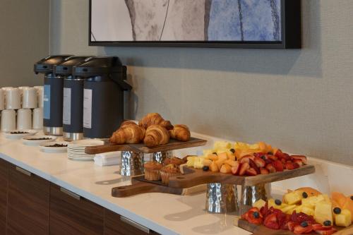 a buffet line with different types of bread and pastries at Courtyard by Marriott Kitchener in Kitchener